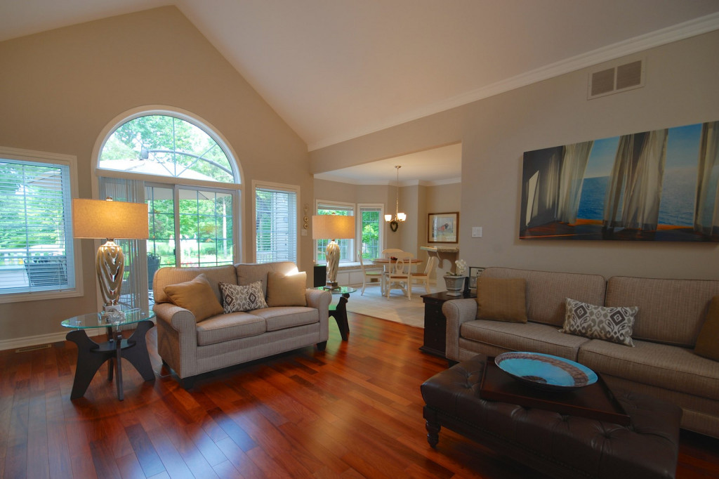 Cathedral ceilings, drenched in light from a triangular window at the peak, a corner gas fireplace, Rosewood floors, sliding doors opening to a gardener's or golfer's dream landscape...